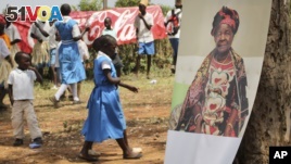 A poster of Sarah Obama, the step-grandmother of President Barack Obama, is displayed during a groundbreaking ceremony for her Mama Sarah Obama Foundation charitable organization, in her home town of Kogelo, near Kisumu, in Kenya Saturday, July 18, 2015.