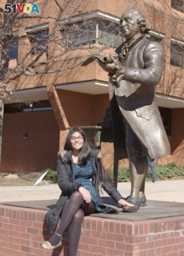 Soulin Reyes at the George Mason statue. It is considered good luck to rub the statue's foot.