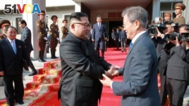 FILE - South Korean President Moon Jae-in shakes hands with North Korean leader Kim Jong Un during their summit at the truce village of Panmunjom, North Korea, May 27, 2018. (Handout photo from KCNA via Reuters)