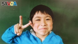 In this undated photo released Friday, 7-year-old Yamato Tanooka was shown at his elementary school. He was found safe Friday nearly a week after he was abandoned in the forest by his parents in northern Japan. (Hamawake Elementary School/Kyodo News via AP) 