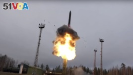 In this photo taken from undated footage distributed by Russian Defense Ministry Press Service, an intercontinental ballistic missile lifts off from a truck-mounted launcher somewhere in Russia.