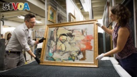 University of Arizona staff members prepare to examine Willem de Kooning's work after it was returned to the school.