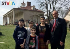 Bibi Mariam Jamalzai (C) poses for a photo with her family on the day that she became an American citizen at Mount Vernon Feb. 22, 2017. With Jamalzai are her husband, Azmat (R) and their three children, from left, Ahmad, Sara and Mustafa.