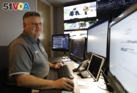 In this July 30, 2019, photo, Paul Hildreth, emergency operations coordinator for the Fulton County School District, works in the emergency operations center at the Fulton County School District Administration Center in Atlanta. (AP Photo/Cody Jackson)