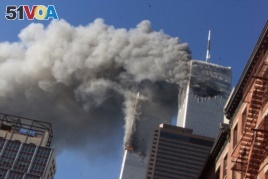 In this Sept. 11, 2001 file photo, smoke rising from the burning twin towers of the World Trade Center after hijacked planes crashed into the towers, in New York City.