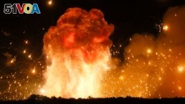 FILE - A powerful explosion is seen in the ammunition depot at a military base in Kalynivka, west of Kiev, Ukraine, early Wednesday, Sept. 27, 2017. (AP Photo/Efrem Lukatsky)