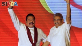 Former Sri Lankan president Mahinda Rajapaksa, left, and former Defense Secretary and his brother Gotabaya Rajapaksa wave to supporters during a party convention held to announce the presidential candidacy in Colombo, Sri Lanka, Sunday, Aug. 11, 2019. (AP