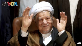  In this Dec. 21, 2015 file photo, former Iranian President Akbar Hashemi Rafsanjani waves to journalists as he registers his candidacy for the elections of the Experts Assembly, in Tehran, Iran. (AP Photo/Ebrahim Noroozi, File)