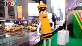 FILE - A dandelion crayon character poses for photos during a Crayola event in New York's Times Square, March 31, 2017. (AP Photo/Richard Drew)