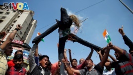 People burn an effigy representing Pakistan as they celebrate after Indian officials said their airplanes carried out airstrikes on militant camps in Pakistani territory, in Ahmedabad, India, February 26, 2019. 