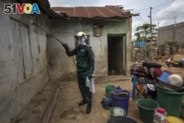 A worker of Anglogold Ashanti Malaria Ltd sprays the walls of a house with insecticide against mosquitos, May 2, 2018 in Adansi Domeabra, near Obuasi, Ashanti Region.