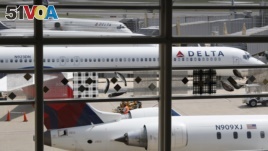 Delta Air Lines planes are seen on the tarmac at Washington's Ronald Reagan Washington's National Airport, Monday, Aug. 8, 2016. (AP Photo/Carolyn Kaster)