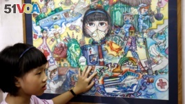 Nguyen Doi Chung Anh, 10, a Vietnamese school girl stands next to her painting about the coronavirus disease (COVID-19) at home in Hanoi, Vietnam June 10, 2020. (REUTERS/Kham)
