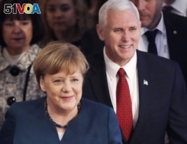German Chancellor Angela Merkel and United States Vice President Mike Pence arrive at the Munich Security Conference in Munich, Germany, Feb. 18, 2017.
