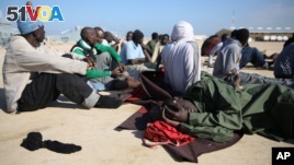 African migrants rest after their rescue by the Libyan Coast Guard west of Tripoli, Dec. 21, 2015.