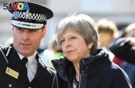 Britain's Prime Minister Theresa May visits Salisbury on March 15, 2018, the British city where a former Russian intelligence officer Sergei Skripal and his daughter Yulia were poisoned two weeks earlier.