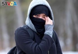 A woman claiming to be from Yemen wipes tears from her eyes as she is told by Canadian police not to enter the U.S.-Canada border into Hemmingford, Quebec Canada February 22, 2017.