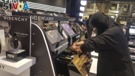 In this Thursday, April 19, 2018 photo, Najla Sultan bin Awwad works at Sephora in Riyadh. The mother of two in her 30s started working for the first time a year ago at the store, says even women who cover their face with a veil are becoming bolder in public.