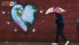 A man walks past a mural the day before Earth Day, in Philadelphia. (File)