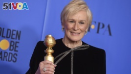 Glenn Close poses in the press room with the award for best performance by an actress in a motion picture, drama for 