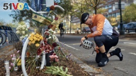 Eric Fleming, 41, stops by to express his condolences in front of a bike memorial where people leave flowers to remember the victims of an ISIS-inspired attack in New York.