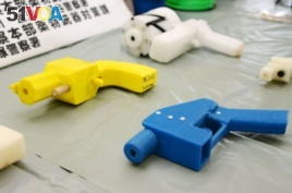 Seized plastic handguns which were created using 3D printing technology are displayed at Kanagawa police station in Yokohama, south of Tokyo, May 8, 2014.