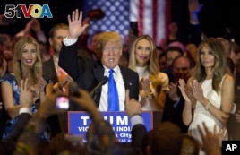 Republican presidential candidate Donald Trump is joined by his wife Melania, right, daughter Ivanka, left, as he speaks during a primary night news conference, Tuesday, May 3, 2016, in New York. (AP Photo/Mary Altaffer)