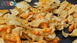 FILE - A mixture of salty snacks and chips is shown on a table in Pittsburgh's Market Square, Feb. 7, 2012. 