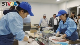 Lab technicians at the Fukushima Prefectural Fisheries Experimental Station at Onahama Port in Iwaki city prepare fish to measure cesium levels for safety tests under the prefecture's experimental fishing program, Oct. 12, 2017.