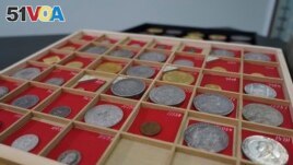 Coins from L. E. Bruun's collection on display on a wooden tray, in Zealand, Denmark, May 7, 2024. The large collection could get up to $72 million. (AP Photo/James Brooks)