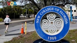 FILE - A student makes her way past the sign at New College of Florida, Jan. 20, 2023, in Sarasota, Fla. (AP Photo/Chris O'Meara, File)