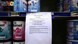 A notice warns customers of precautionary recall of products in a supermarkert of Lille, northern France, Monday, Dec. 11, 2017. Baby milk maker Lactalis and French authorities have ordered a global recall of millions of products over fears of salmonella bacteria contamination. The French company, one of the largest dairy groups in the world, said it has been warned by health authorities in France that 26 infants have become sick since Dec. 1. (AP Photo/Michel Spingler)
