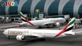 FILE - Emirates Airline Boeing 777-300ER planes are seen at Dubai International Airport in Dubai, United Arab Emirates, February 15, 2019. Several airlines canceled flights to the U.S or changed planes they were using because of concerns about the new 5G service. 
