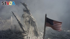An American flag flies near the base of the destroyed World Trade Center in New York, in this file photo from September 11, 2001,