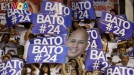 Supporters raise their posters to cheer their senatorial candidate, former national police chief Rogelio 