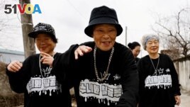 Park Jeom-sun, 81, the leader of the granny rap group Suni and Seven Princesses, along with members Hong Sun-yeon, 79, and Jeong Du-i, 90, raps on the street in Chilgok, South Korea, February 6, 2024. (REUTERS/Kim Soo-hyeon)
