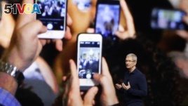 FILE - Apple CEO Tim Cook announces the new iPhone 7 during an event to announce new products, in San Francisco. 