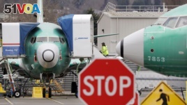 Boeing 737 MAX jets are parked Monday, Dec. 16, 2019, in Renton, Wash. Boeing will temporarily stop producing its grounded 737 MAX jet starting in January as it struggles to get approval from regulators to put the plane back in the air. (AP Photo/Elaine Thompson) 