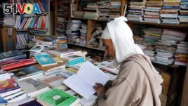 An elderly man reads a book in a bookshop in Bab Doukkala in the city of Marrakech, Morocco, May 13, 2017. (REUTERS/Youssef Boudlal)