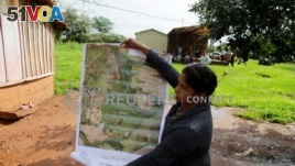 Community leader Cornelia Flores holds a map showing the community's territory which is being monitored with a smartphone app and GPS to protect lands and preserve forests, in Isla Jovai Teju, Paraguay May 9, 2019. (REUTERS/Jorge Adorno)