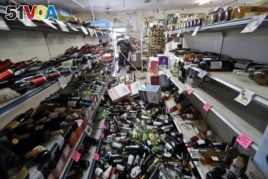Bottles of wine are strewn in the middle of an aisle in the Eastridge Market in Ridgecrest, California, July 6,2019, after Friday night's 7.1-magnitude earthquake, which jolted an area from Sacramento to Mexico.