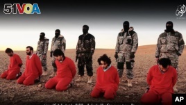 This undated image is taken from video posted online Jan. 3, 2016, by the Islamic State group. The group claims it shows its members executing five men they accuse of spying for Britain in Syria.