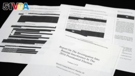 Four pages of the Mueller Report lay on a witness table in the House Intelligence Committee hearing room on Capitol Hill, in Washington, Thursday, April 18, 2019. (AP Photo/Cliff Owen)