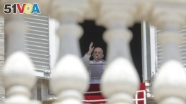 FILE - In this Sunday, June 7, 2020 file photo, Pope Francis delivers his blessing as he recites the Angelus noon prayer from the window of his studio overlooking St.Peter's Square, at the Vatican. (AP Photo/Andrew Medichini, File)