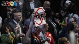 A delegate holds an anti-Trans-Pacific Partnership (TPP) trade agreement sign during the first day of the Democratic National Convention in Philadelphia, July 25, 2016. 