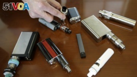 This April 10, 2018 photo shows vaping devices taken from students at Marshfield High School in Marshfield, Mass. (AP Photo/Steven Senne)