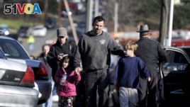 In the U.S., parents reunite with their children following a shooting at Sandy Hook Elementary School in Newtown, Connecticut. A gunman killed 27 people dead, including 20 children, on Dec. 14, 2012.