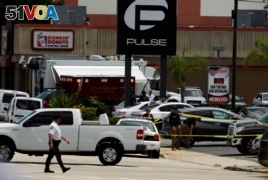 Police continue to investigate a shooting at the Pulse night club following an early morning shooting attack in Orlando, Florida, June 12, 2016.