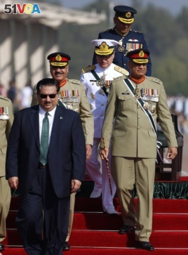 Pakistan Defense Minister Khurram Dastgir, left, with Army Chief Qamar Javed Bajwa, right, and other officers arrive for a military parade in Islamabad, Pakistan, Friday, March 23, 2018. (AP Photo/Anjum Naveed)