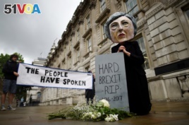 A protester wearing a Theresa May mask is seen the day after Britain's election in London, June 9, 2017.